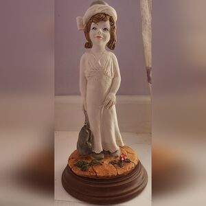 Capodimonte figurine of a girl holding a purse. Figurine is called Casablanca